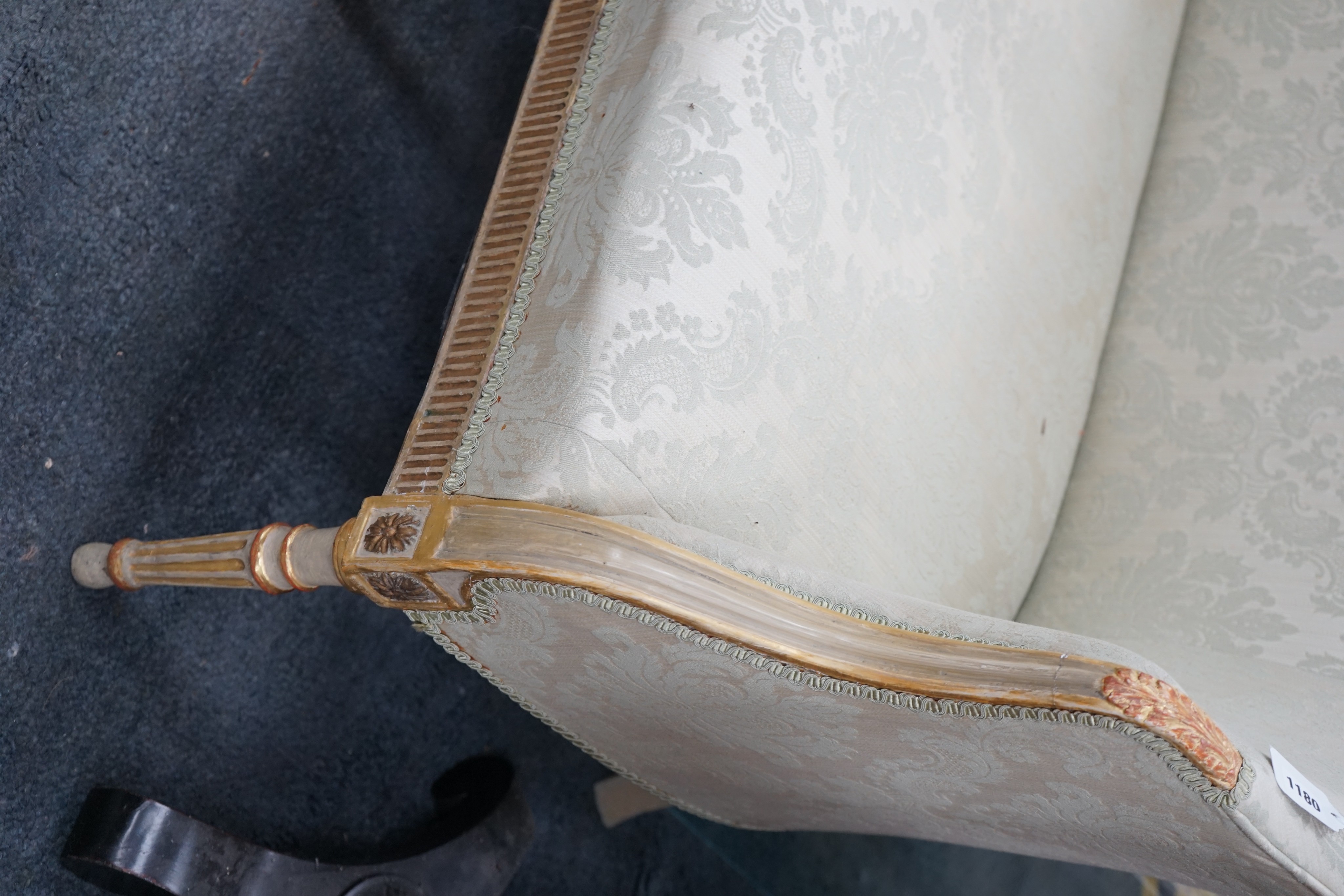 A French painted parcel gilt framed settee, length 148cm, depth 60cm, height 89cm